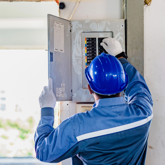 electrician checking an electrical panel